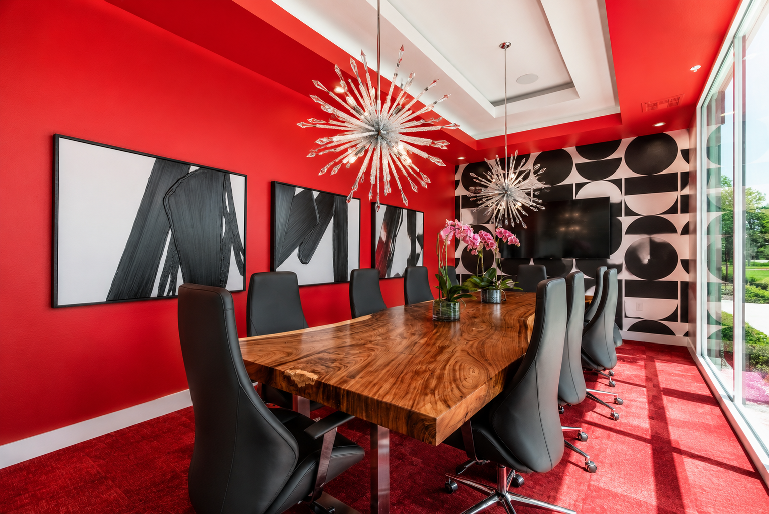 Modern Storage® Hot Springs conference room with red walls, modern lighting, black chairs, and a large wood meeting table